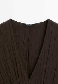 Dark brown V-neck top with textured, pleated fabric and a subtle sheen. Label reads "Massimo Dutti," attached at the neckline.