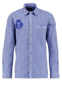 Chemise à carreaux bleu et blanc avec manches longues, patte de boutonnage, poche poitrine et motif brodé sur le côté gauche. Col contrasté.