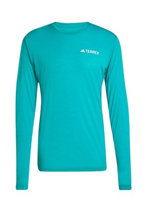 Pitkähihaista teal-väristä paitaa, joka on valmistettu kevyestä kankaasta. Paidassa on pyöreä kaula-aukko ja "Terrex"-logo valkoisena rinnassa.