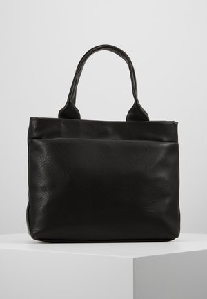 Black leather tote bag with two handles, rectangular shape, and pebbled texture, standing on a white surface against a light background.