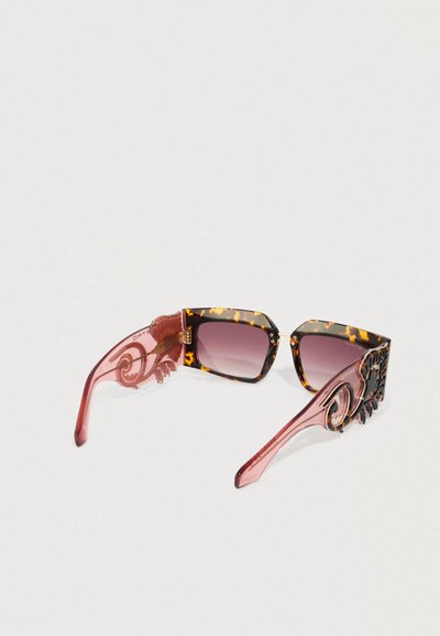 Occhiali da sole quadrati in tartaruga con lenti sfumate e aste trasparenti rosa con intricati motivi a spirale.