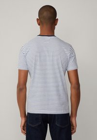 Striped T-shirt featuring horizontal navy stripes on a white background, crew neck, short sleeves, and a relaxed fit.