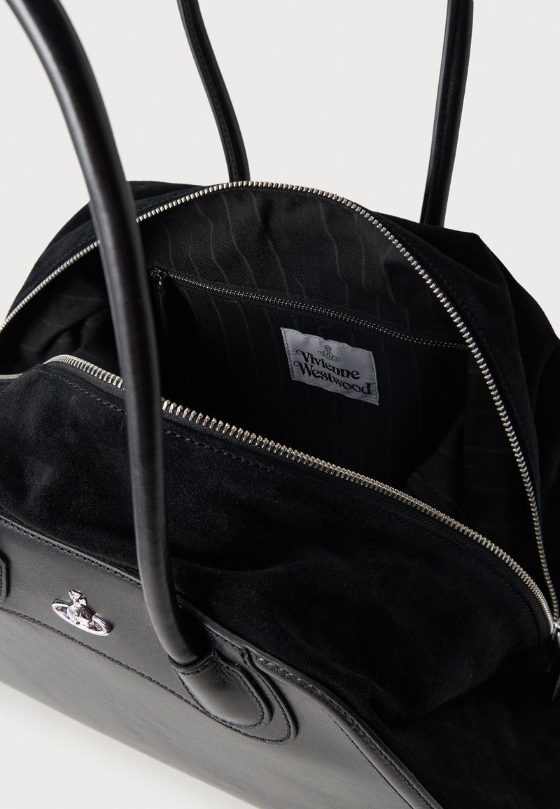 Black leather and suede tote bag with silver zipper, two handles, interior zip pocket, and visible Vivienne Westwood label.