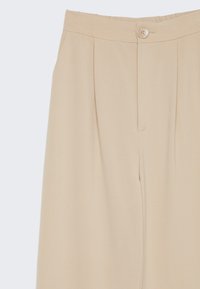 Beiga, högmidjade byxor med en slät yta, framfållningar och en enkel knappstängning i midjan. Skräddarsydd design.