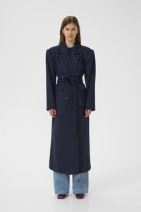 Navy blue long coat made of wool, featuring a double-breasted design, wide lapels, a tied waist, and side pockets.
