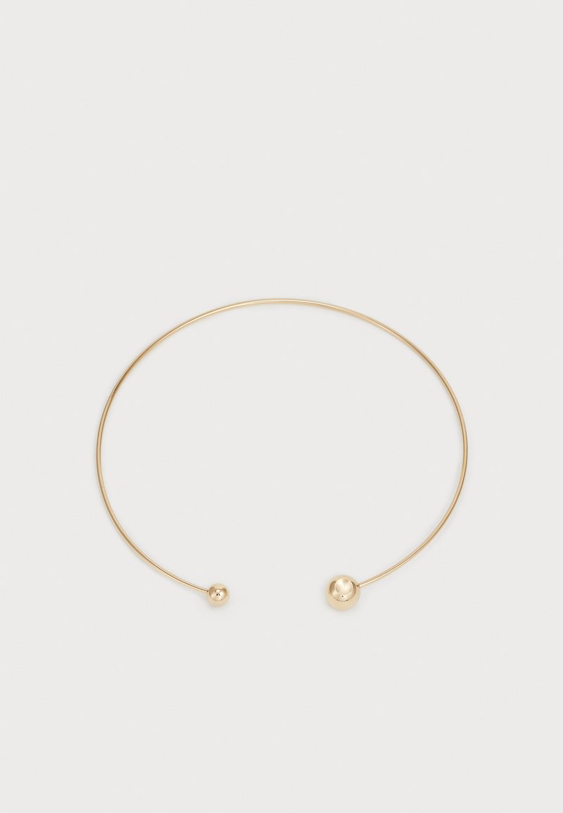 Kuldmetalne choker kaelakee, millel on minimalistlik disain, koos õhukese traadi ja kahe sfäärilise palliga mõlemal otsal. Sile, poleeritud pind.