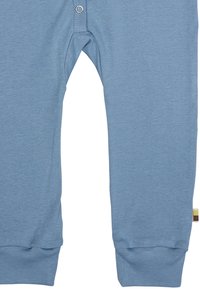 Leggings in cotone azzurro chiaro con texture a coste, dotati di una vita elasticizzata, chiusura con bottone a pressione e polsini affusolati.