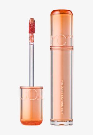 Flacon de teinte à lèvres et applicateur avec embout en éponge douce, liquide de teinte pêche visible à l'intérieur d'un emballage transparent orange.