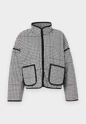 Mustavalkoinen ruudullinen puuvillapukine, jossa on korkea kaulus, edessä vetoketju ja kaksi suurta läpätaskua, mustilla yksityiskohdilla viimeistelty.