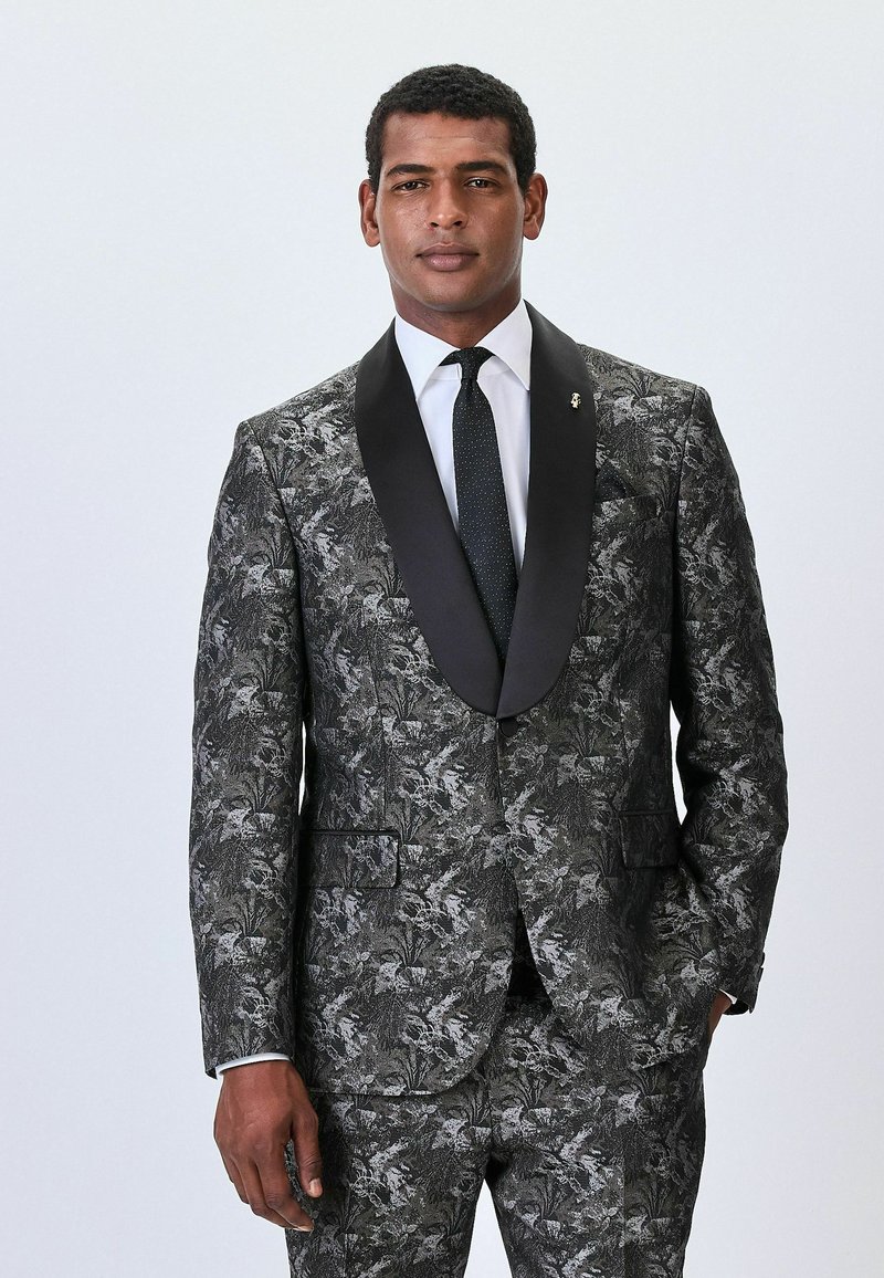 Black and silver floral patterned suit with a black satin shawl collar, white shirt, and dotted tie. Slim-fit design with picket pockets.