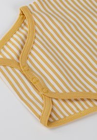 Yellow and white striped baby bodysuit with snap buttons along the bottom seam on a white background.
