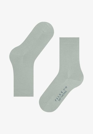 Chaussettes basses vert clair en matériau doux, avec une texture lisse et un bout sans couture. Marque et taille imprimées en bleu sous la chaussure.