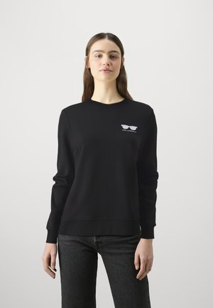 Black sweatshirt made of soft fabric featuring a crew neck, long sleeves, and white sunglasses graphic on the left chest.