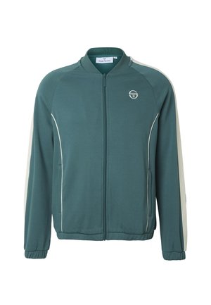 Turkis zip-up jakke med hvite sidestriper og piping, elastiske mansjetter og en liten rund logo på venstre bryst.