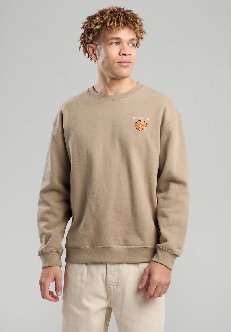 Beige crewneck sweatshirt made of cotton, featuring an embroidered flower design and "CALIFORNIA" text on the chest. Loose fit.