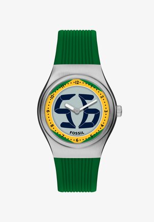 Zilveren Fossil polshorloge met groene siliconen band, gele en groene wijzerring, donkerblauw abstract ontwerp en witte uur- en minutenwijzers.