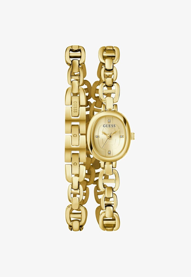 Arany színű karóra ovális számlappal, láncos dizájnnal, fényes felülettel és kristályos díszítéssel az óraszámlapon. A logó a pánton szerepel.