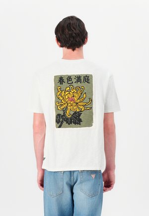 Short-sleeve white cotton t-shirt featuring a large yellow chrysanthemum design on a green background with Japanese text on the back.