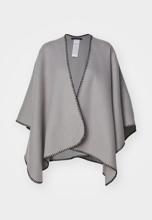 Poncho gris clair à ouverture avant avec bordure en point de fouet noire, drapé de manière asymétrique pour une coupe décontractée, présenté sur un fond blanc.