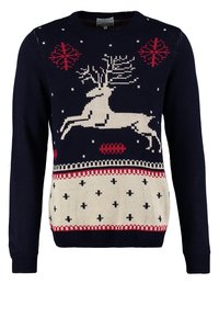 Marinblå stickad tröja med en vit ren-design, röda detaljer och snöflingormönster. Ribbad mudd och nederkant, med en beige nedre del och kors.