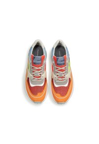 Multicolored sneakers featuring a mesh upper with orange, red, and green accents, a textured orange sole, and gray laces.