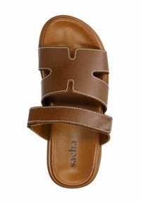 Brown leather slide sandal with two wide straps, cut-out design, contrasting white stitching, and cushioned footbed. Brand name printed inside.