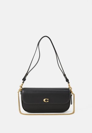 Black leather shoulder bag with gold chain detail and gold "C" logo on front flap, against a white background.