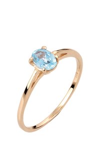 Goldring mit einem glatten Band und einem ovalen, hellblauen Edelstein als Mittelpunkt, der von vier Krallen sicher gehalten wird.