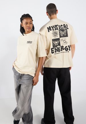 Beige cotton t-shirts with short sleeves. Front features small black text; back displays graphic designs including sun, butterfly, and hands.