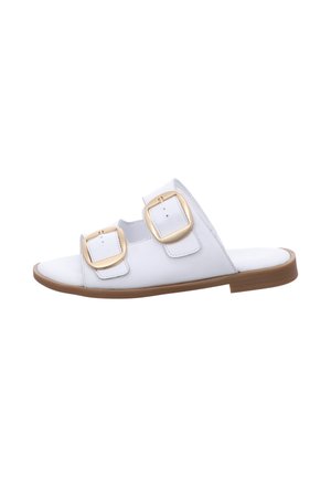 White slide sandals featuring two large gold square buckles, a smooth upper material, and a flat tan sole. Simple design and open-toe style.