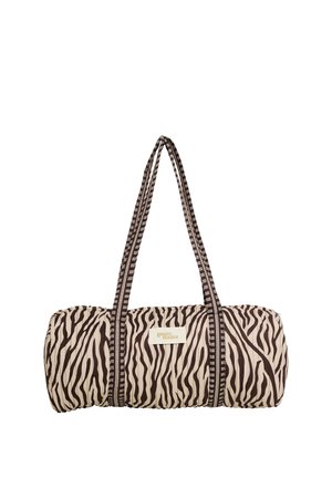 Bolsa redonda para esterilla de yoga con estampado de cebra, correas largas para el hombro a rayas negras y blancas, y una etiqueta "grain de malice" en el lateral.
