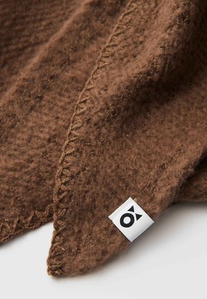 Brown wool blanket with a soft texture, featuring a stitched edge and a small white label with a black logo at the corner.