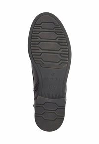 Suela de zapato de cuero negro con tapones de goma texturizados, con patrones hexagonales. Logotipo estampado y tamaño 37 visible en el lateral.