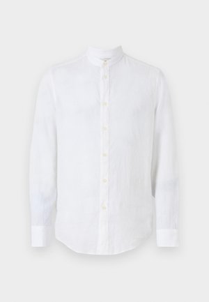 Bílá lněná košile s mandarínským límcem. Má dlouhé rukávy, zapínání na knoflíky vpředu a zakřivený lem. Jemná textura.