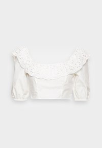 Blusa cropped branca com um decote de renda de ilhós texturizado e mangas bufantes com punhos elásticos. Tecido de algodão liso, design minimalista.