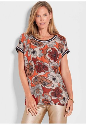 Bluse mit floralem Muster in Orange und Beige. Glattes Material mit kurzen Ärmeln und einem runden Ausschnitt, eingefasst mit schwarzem Rand.