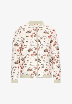 Blomstrede bomberjakke i creme med grønne kanter, der har et tropisk mønster af blomster, huse, både og palmetræer på blødt stof.