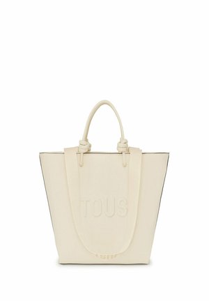 Bolso tote de color marfil con el logo "TOUS" en relieve, que cuenta con asas resistentes, un diseño estructurado y un ribete negro en contraste.