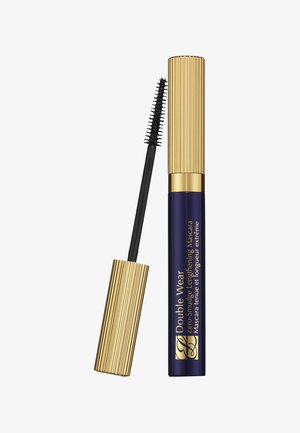 Tube de mascara avec bouchon doré côtelé et applicateur baguette montrant des poils noirs, étiqueté "Double Wear Zero-Smudge Lengthening Mascara".