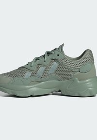 Green mesh sneakers featuring a textured rubber sole, patterned overlays, and decorative lacing with light blue accents.