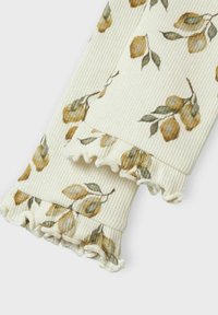 Ribbed fabric sleeves in cream with a floral print featuring yellow flowers and green leaves. Edges adorned with ruffled trim.