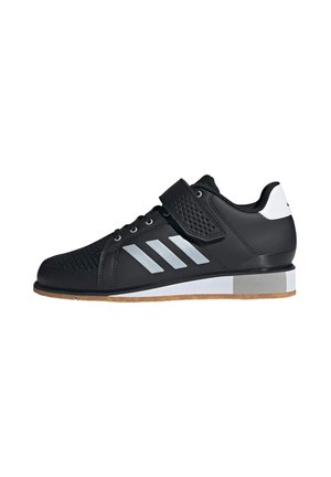 Zwarte sportieve schoen met een bovenwerk van mesh, grijze accenten, rubberen zool en een klittenbandsluiting voor een veilige pasvorm. Bevat een logo met drie strepen.