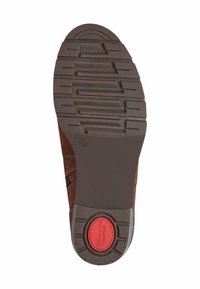 Brown leather shoe sole with textured grip pattern, featuring a red circular accent labeled "comfort" and a rounded heel design.