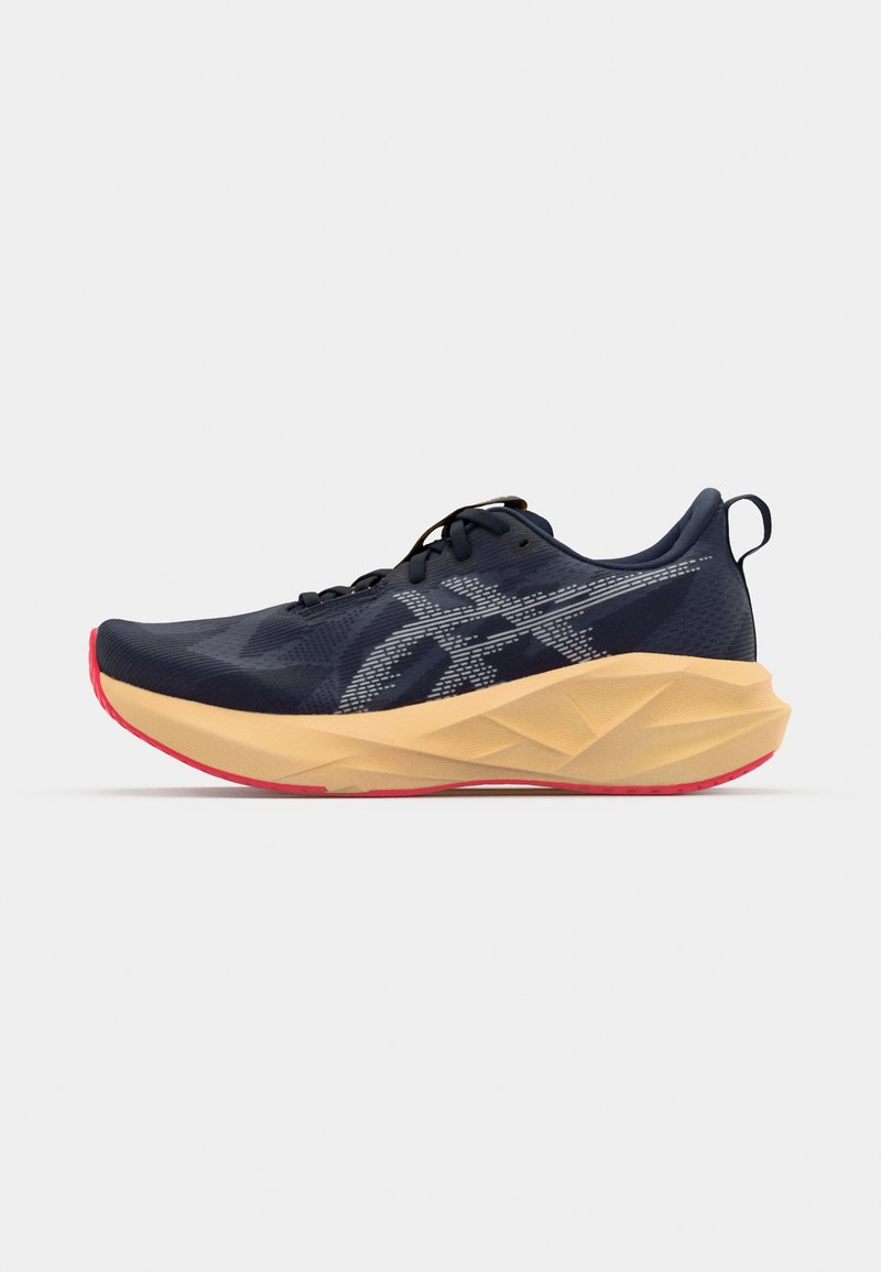 Navy athletic shoe with a textured mesh upper, beige midsole, and red outsole. Features a lace-up design and reinforced heel tab.