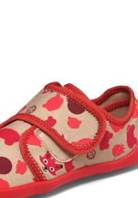 Children's shoe with red accents, beige fabric featuring fox and berry patterns, adjustable strap, and textured rubber sole.