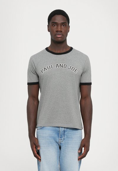 Gray cotton t-shirt featuring a black neckline and sleeve accents, with "PAUL AND JOE" printed in a curved white font across the chest.