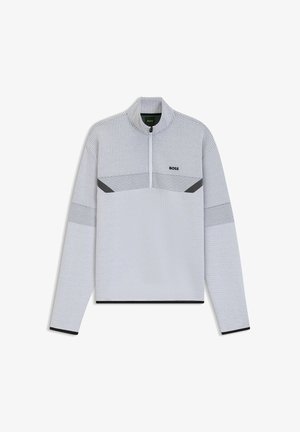 Lys grå lynlåspullover lavet af tekstureret stof. Har et geometrisk mønster på brystet med sorte accenter på ærmerne og kanten.