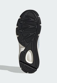 Black rubber sole with textured traction pattern, featuring a wavy design and beige accents. Text on the sole reads "CLOUDFOAM."