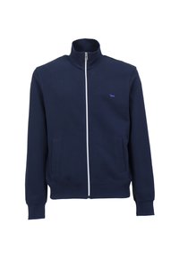 Chaqueta de navegación con cremallera, hecha de tejido suave, con un cuello alto, cremallera blanca, dos bolsillos frontales y un pequeño logo morado.