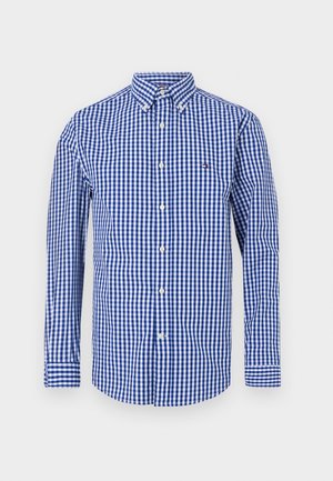 Camisa de cuadros vichy azul y blanca con mangas largas, cuello abotonado y pequeño logo en el pecho izquierdo. Fabricada con algodón tejido.